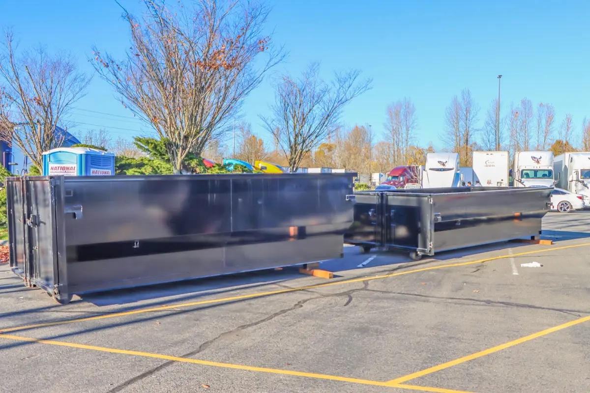 Professional dumpster rental service with roll-off container on residential driveway in Gantt